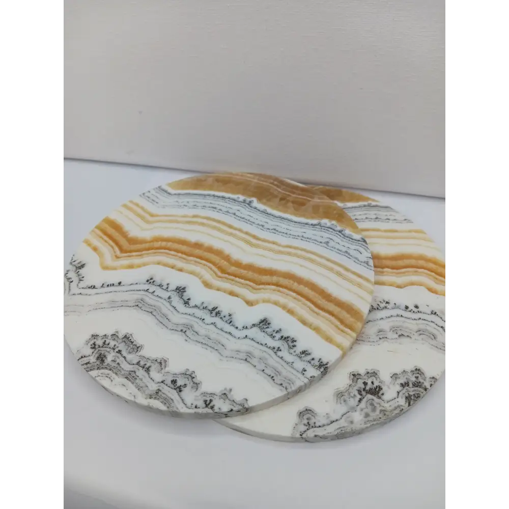 Dendritic Orange Calcite charging plate, 5.5 inches, with vibrant orange hues and natural dendritic patterns, displayed on a white background.