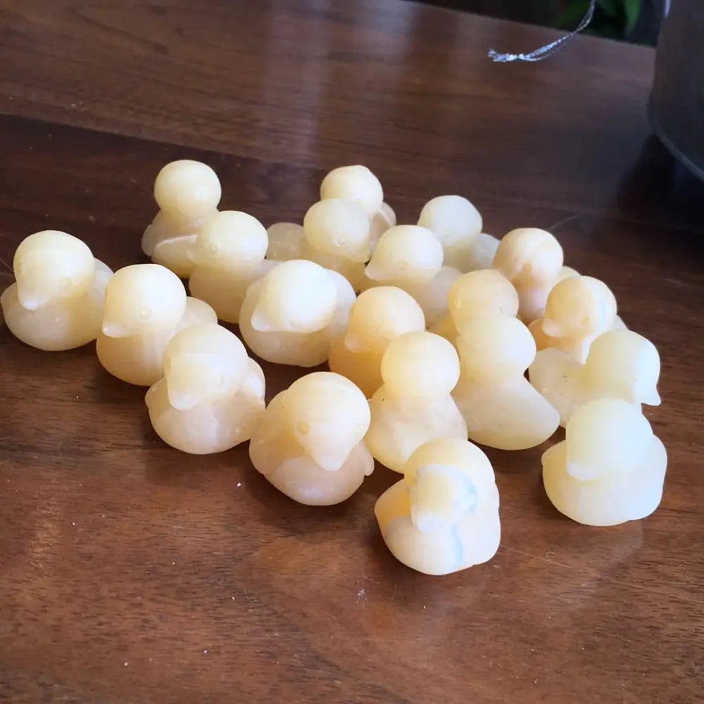 Hand-carved orange calcite mini duck with vibrant orange hues, displayed on a white background. Perfect for joy, playfulness, and creative energy.