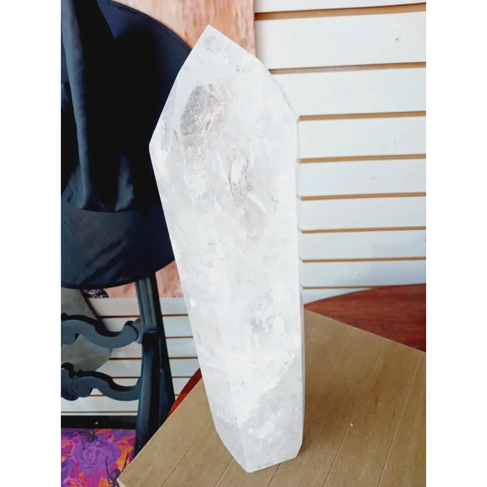Diamantina clear quartz tower, 17 inches tall, polished with exceptional clarity and natural inclusions, displayed on a white background.