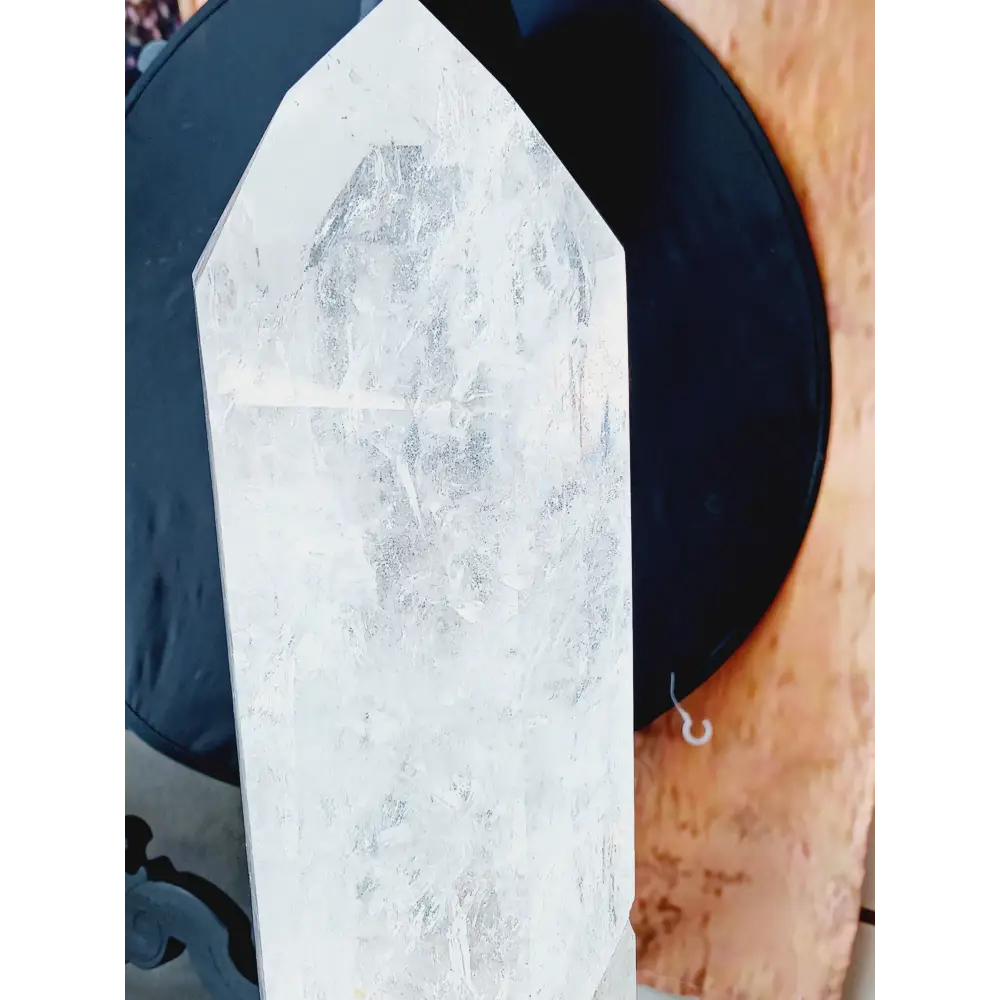 Diamantina clear quartz tower, 17 inches tall, polished with exceptional clarity and natural inclusions, displayed on a white background.