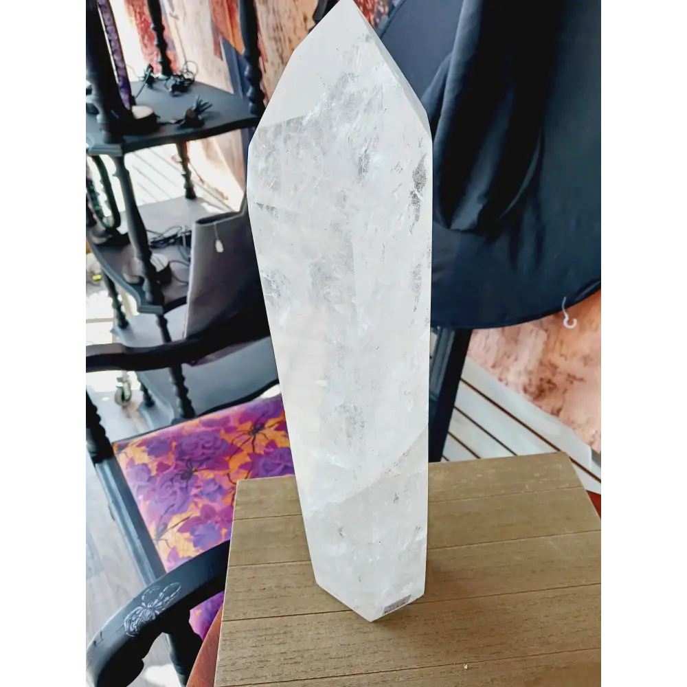 Diamantina clear quartz tower, 17 inches tall, polished with exceptional clarity and natural inclusions, displayed on a white background.