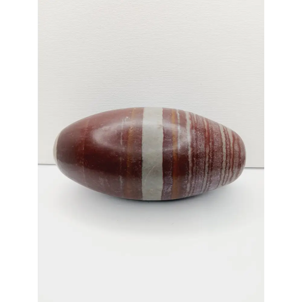Shiva Lingam stones, polished with natural earthy patterns, available in sizes 1" to 8", displayed on a white background.