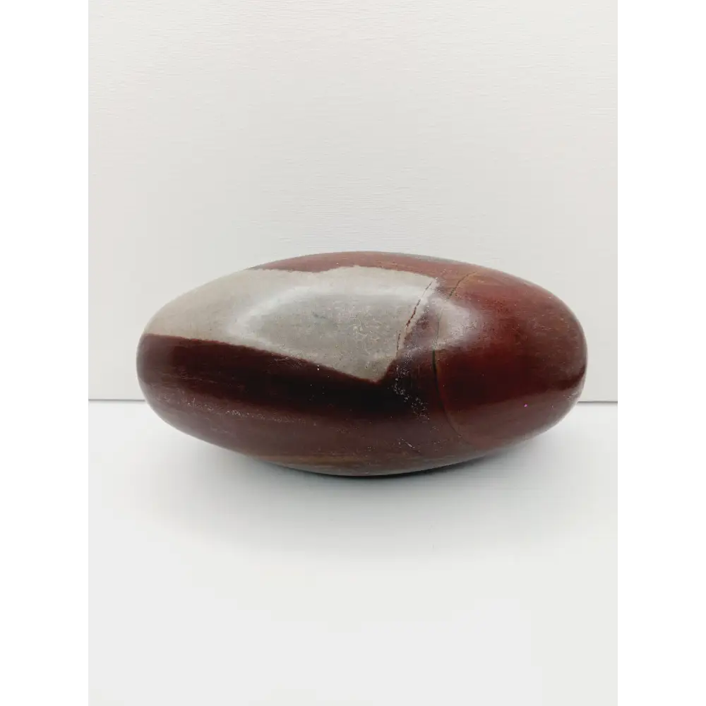 Shiva Lingam stones, polished with natural earthy patterns, available in sizes 1" to 8", displayed on a white background.