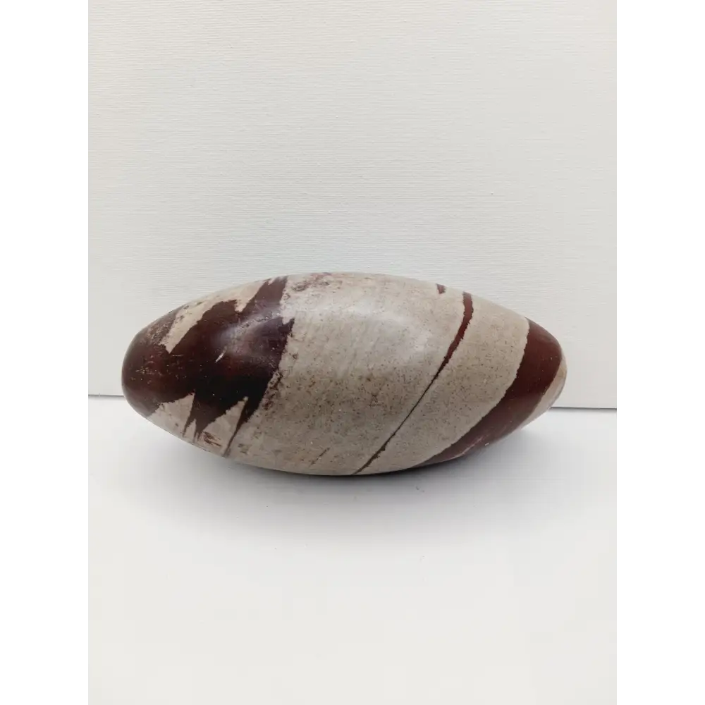 Shiva Lingam stones, polished with natural earthy patterns, available in sizes 1" to 8", displayed on a white background.
