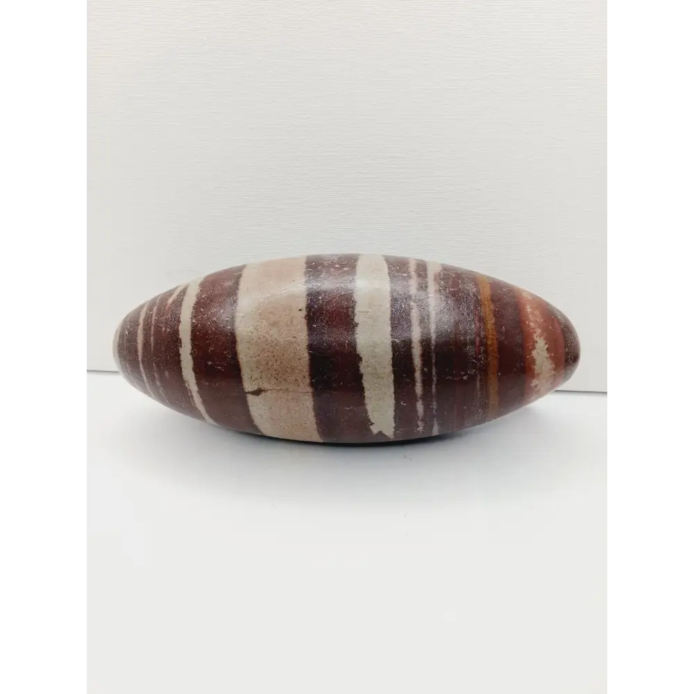 Shiva Lingam stones, polished with natural earthy patterns, available in sizes 1" to 8", displayed on a white background.