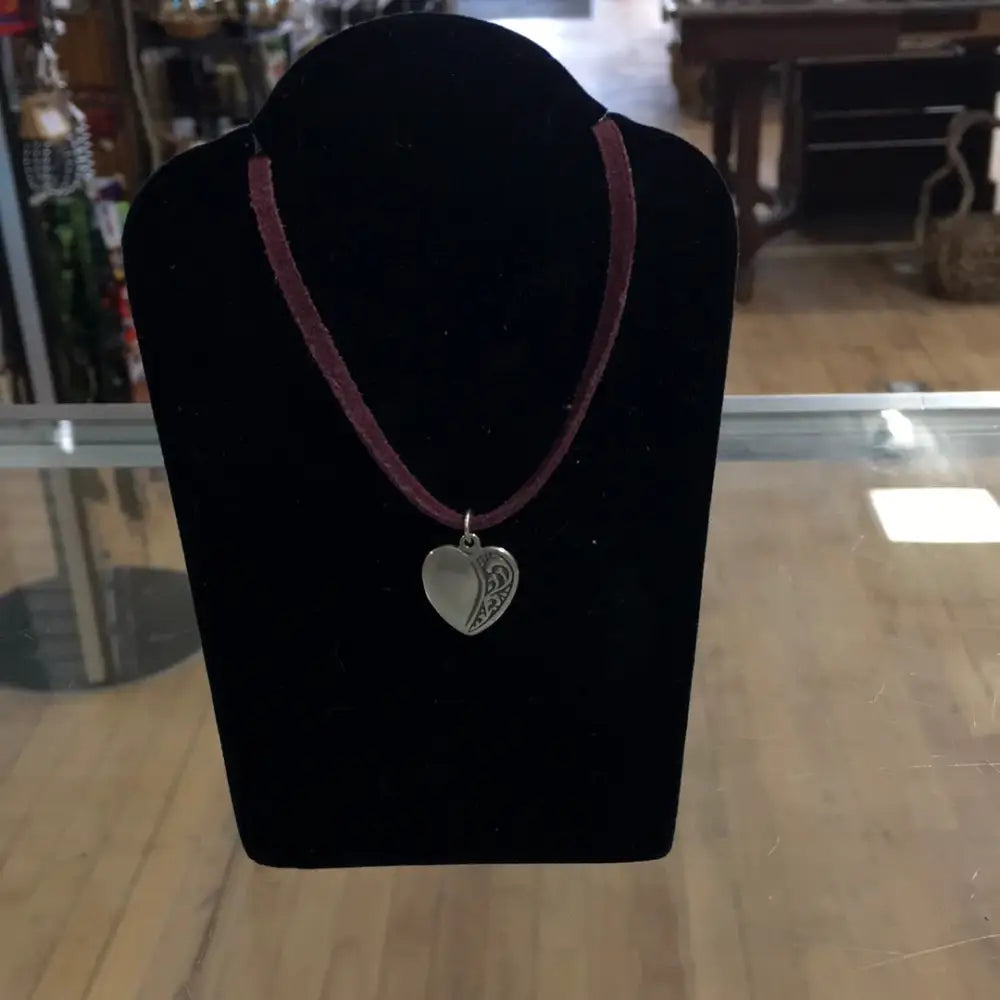Sterling silver heart pendant with a classic, polished finish, displayed on a white background. Perfect for love, compassion, and timeless elegance.