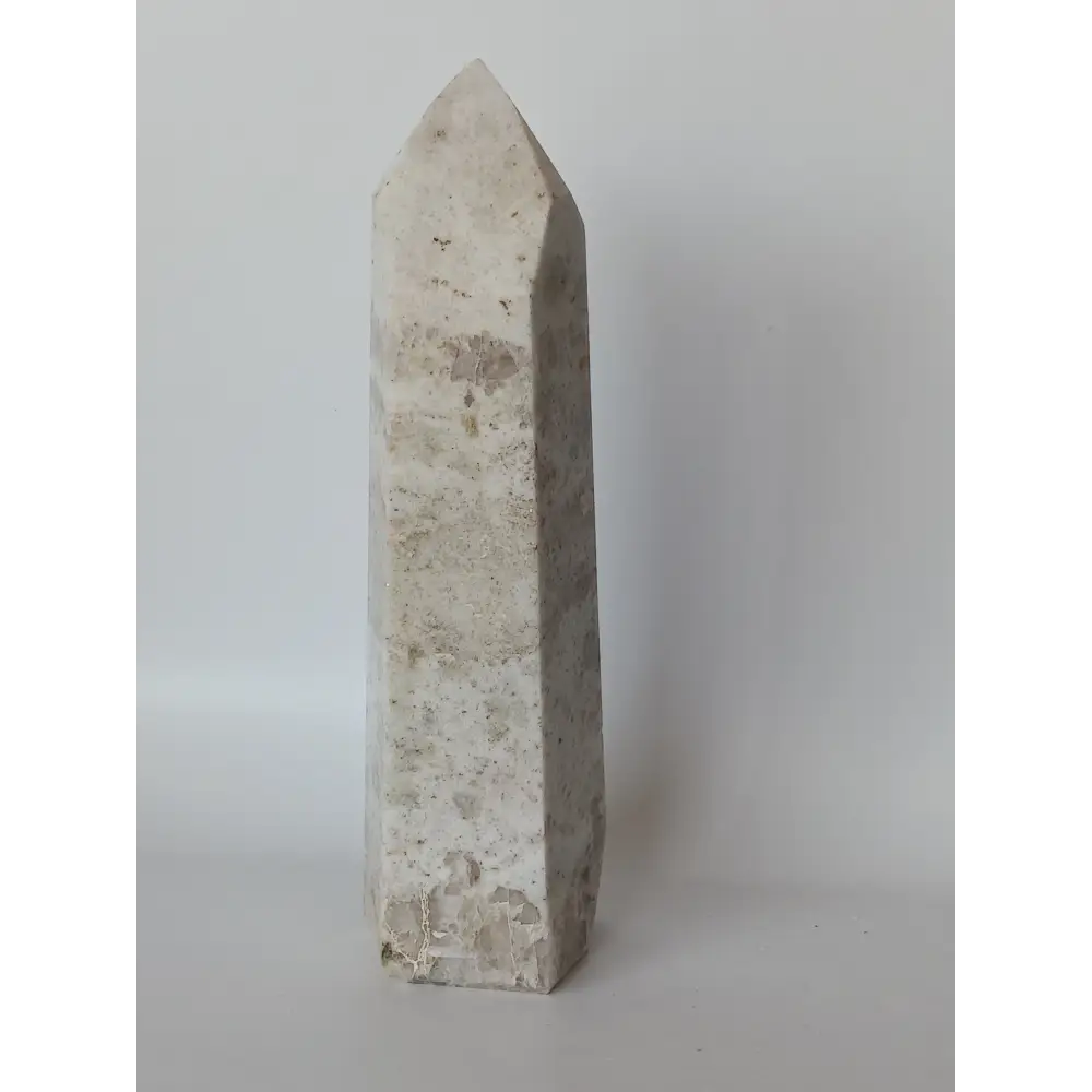 Hand-carved Albite Mica tower featuring radiant white albite with shimmering mica inclusions, displayed on a white background.