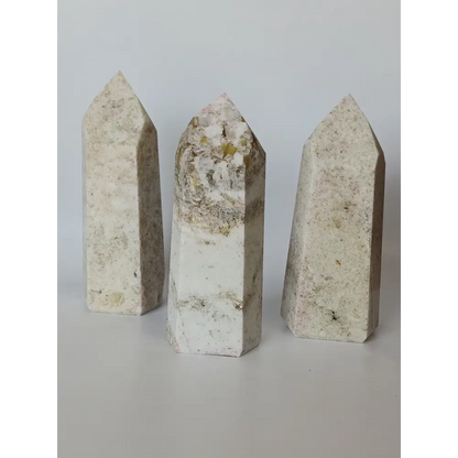 Hand-carved Albite Mica tower featuring radiant white albite with shimmering mica inclusions, displayed on a white background.