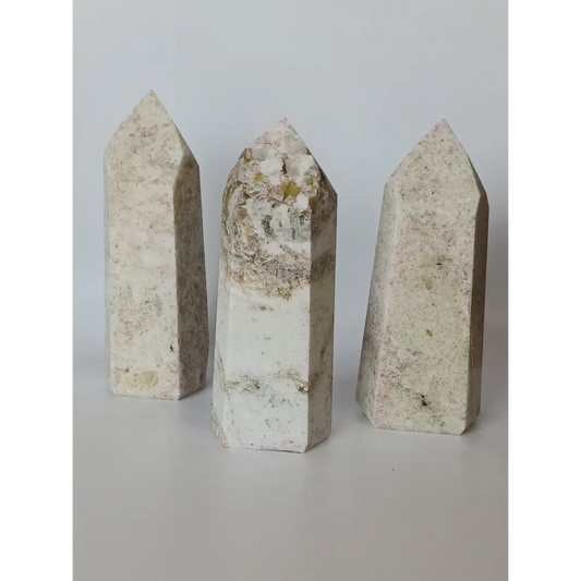 Hand-carved Albite Mica tower featuring radiant white albite with shimmering mica inclusions, displayed on a white background.