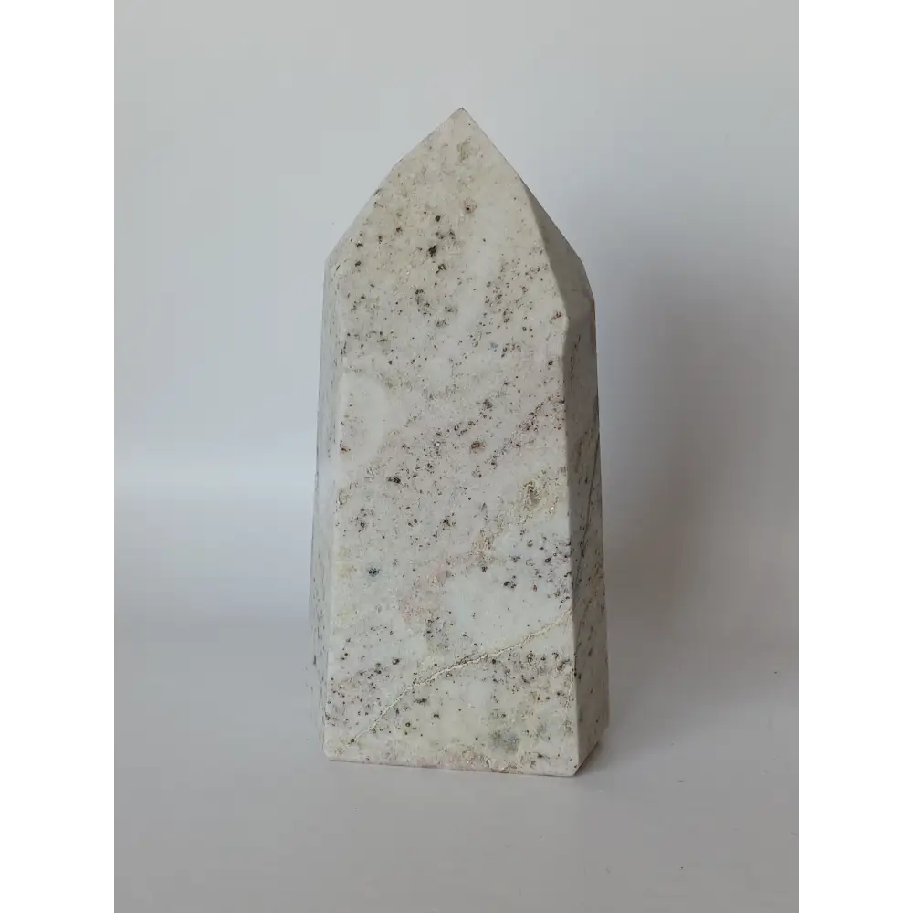 Hand-carved Albite Mica tower featuring radiant white albite with shimmering mica inclusions, displayed on a white background.