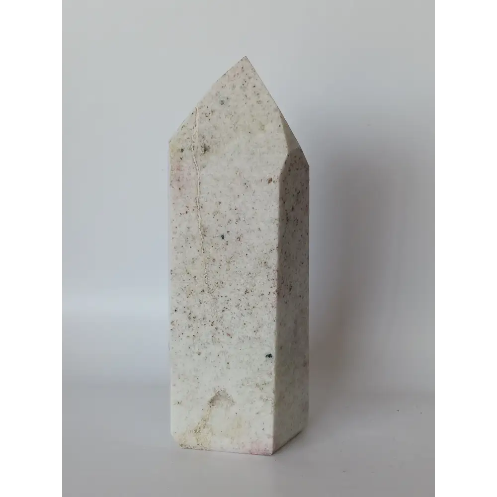 Hand-carved Albite Mica tower featuring radiant white albite with shimmering mica inclusions, displayed on a white background.