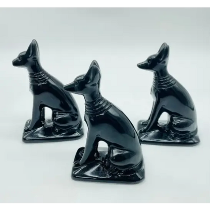 Hand-carved 4-inch Anubis crystal statue featuring a jackal-headed figure with intricate details, made from genuine crystal and displayed on a white background.

