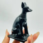Hand-carved 4-inch Anubis crystal statue featuring a jackal-headed figure with intricate details, made from genuine crystal and displayed on a white background.

