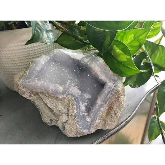 Polished Blue Lace Agate specimen with soft blue and white banding, displayed on a white background. Perfect for calming communication and gentle peace.