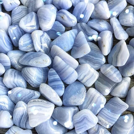 Polished blue lace agate tumble with soft blue and white bands, displayed on a white background. Perfect for calm, communication, and gentle healing.
