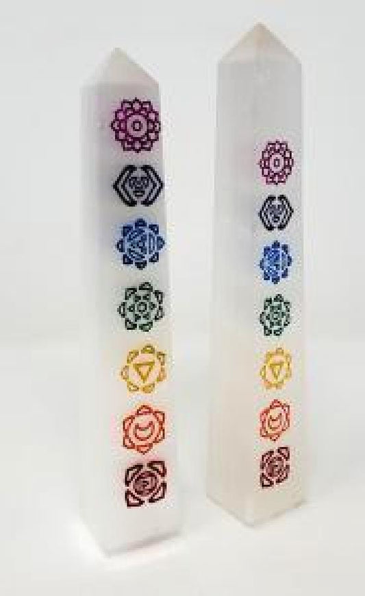 Hand-carved selenite obelisk with vibrant chakra stones arranged vertically, displayed on a white background. Perfect for cleansing, chakra alignment, and high-vibrational energy.