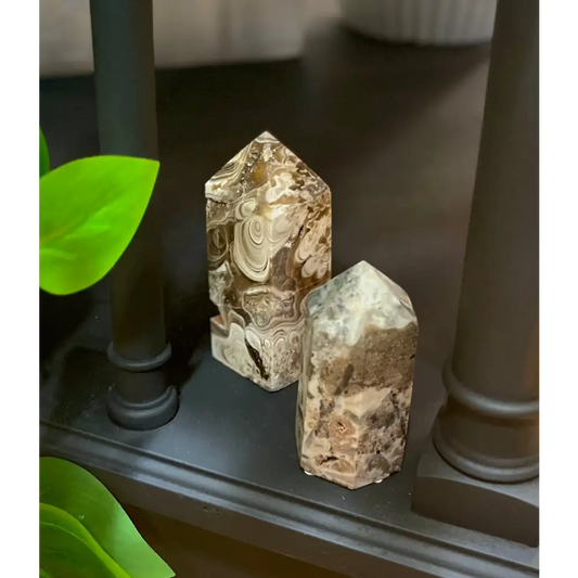 Hand-carved Mexican Crazy Lace Agate tower featuring intricate, colorful swirls and banded patterns, displayed on a white background.