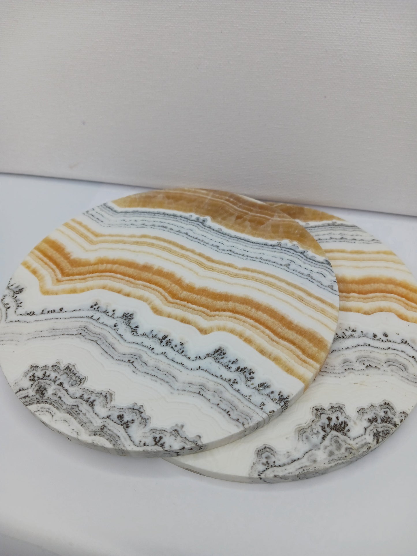 Dendritic Orange Calcite charging plate, 5.5 inches, with vibrant orange hues and natural dendritic patterns, displayed on a white background.