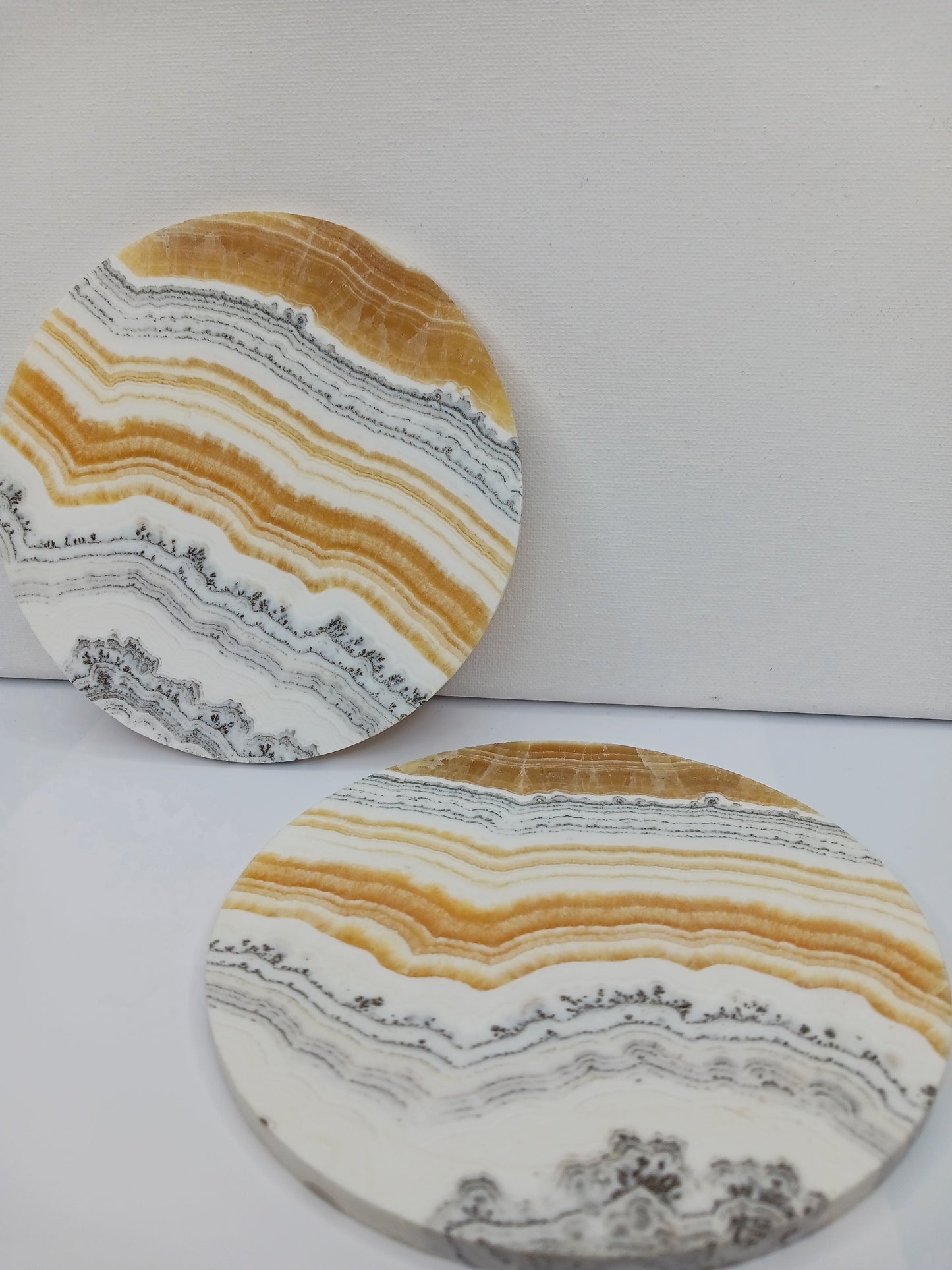 Dendritic Orange Calcite charging plate, 5.5 inches, with vibrant orange hues and natural dendritic patterns, displayed on a white background.