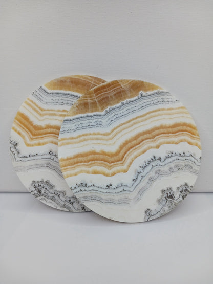 Dendritic Orange Calcite charging plate, 5.5 inches, with vibrant orange hues and natural dendritic patterns, displayed on a white background.