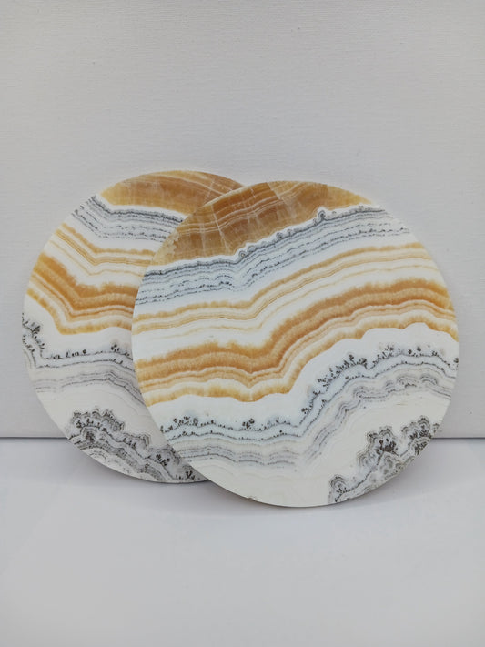 Dendritic Orange Calcite charging plate, 5.5 inches, with vibrant orange hues and natural dendritic patterns, displayed on a white background.