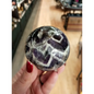 Hand-polished Dream Amethyst sphere featuring vivid purple and white chevron bands, displayed on a white background.