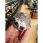 Hand-polished Dream Amethyst sphere featuring vivid purple and white chevron bands, displayed on a white background.