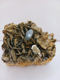 Muscovite with aquamarine specimen, showcasing shimmering layers and blue crystal accents, displayed on a white background.