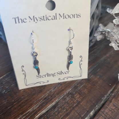 Sterling silver earrings featuring an abstract feather design, displayed on a white background. Perfect for freedom, artistic expression, and modern magic.