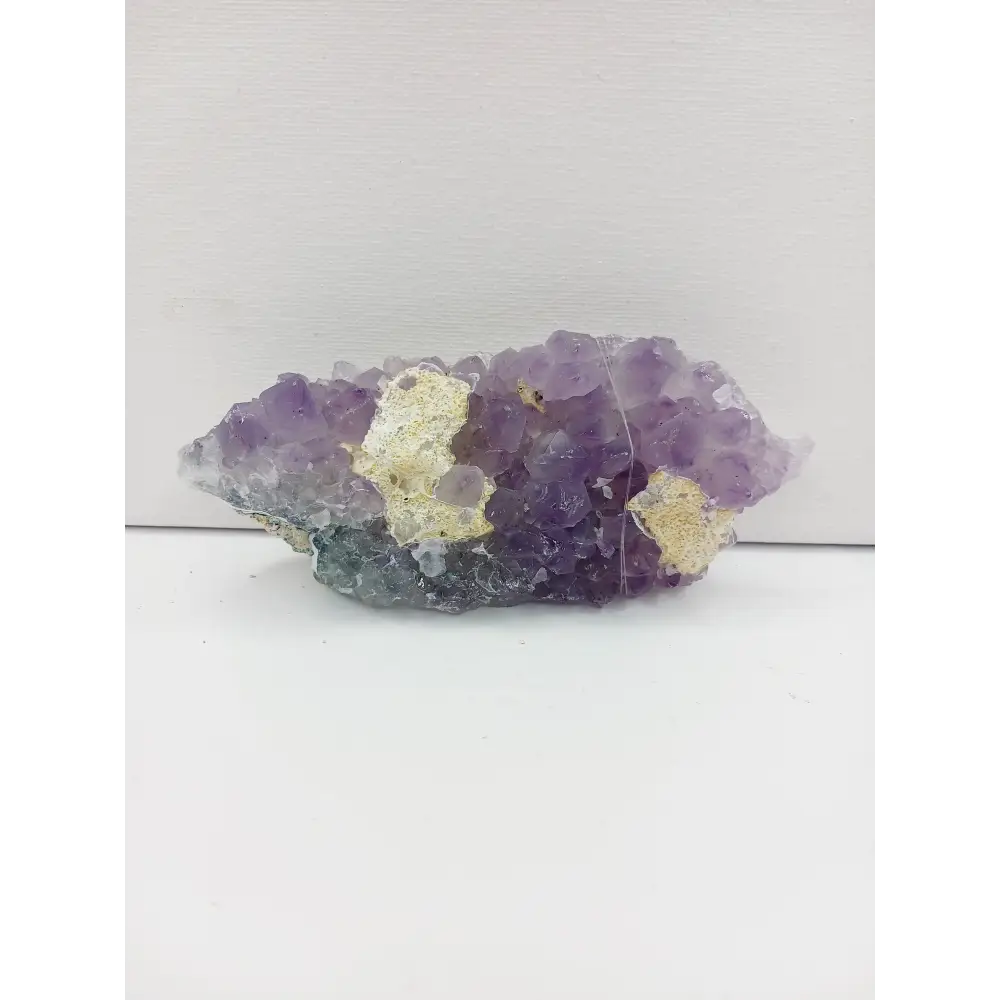 Fine glittery amethyst specimen, featuring sparkling purple points and a shimmering surface, displayed on a white background.
