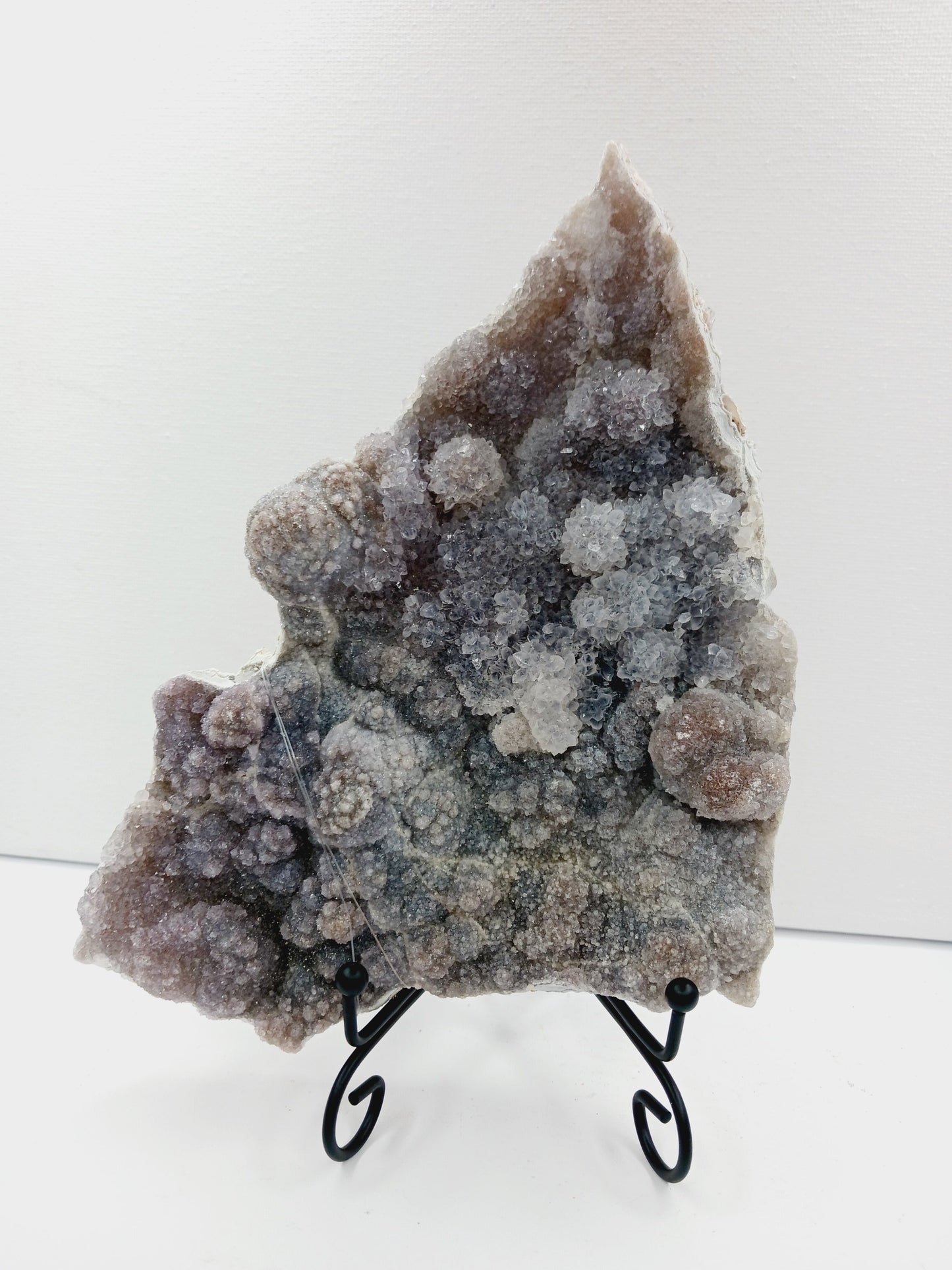 Fine glittery amethyst specimen, featuring sparkling purple points and a shimmering surface, displayed on a white background.
