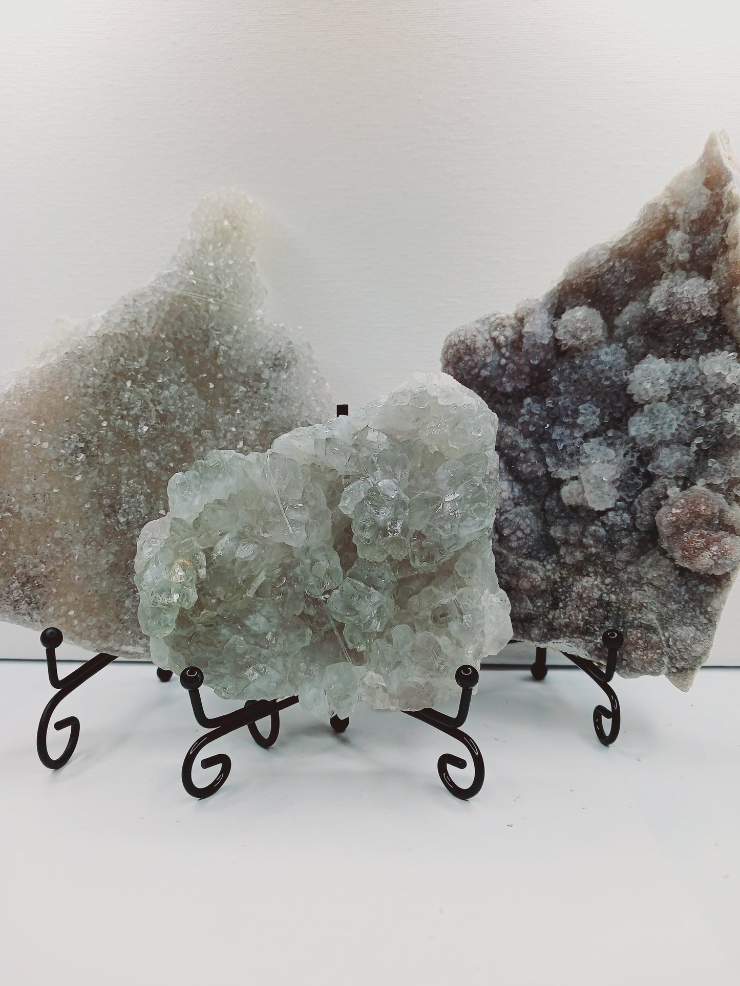 Fine glittery amethyst specimen, featuring sparkling purple points and a shimmering surface, displayed on a white background.