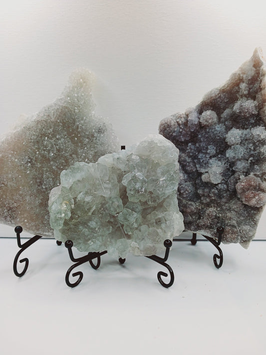 Fine glittery amethyst specimen, featuring sparkling purple points and a shimmering surface, displayed on a white background.