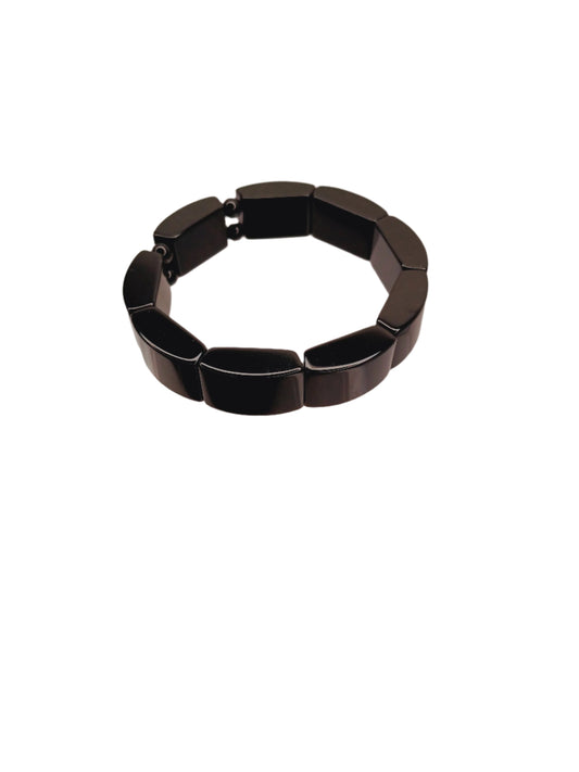 Black bracelet on a clear stand against a white background