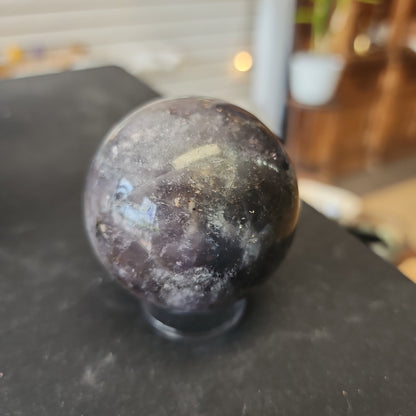 Hand-polished Fluorite with Pyrite sphere featuring vibrant green, purple, or blue fluorite hues with sparkling pyrite inclusions, displayed on a white background.