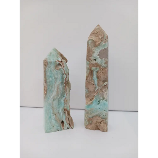 Hand-carved Gemy Hemimorphite tower with sparkling blue hues, displayed on a white background.