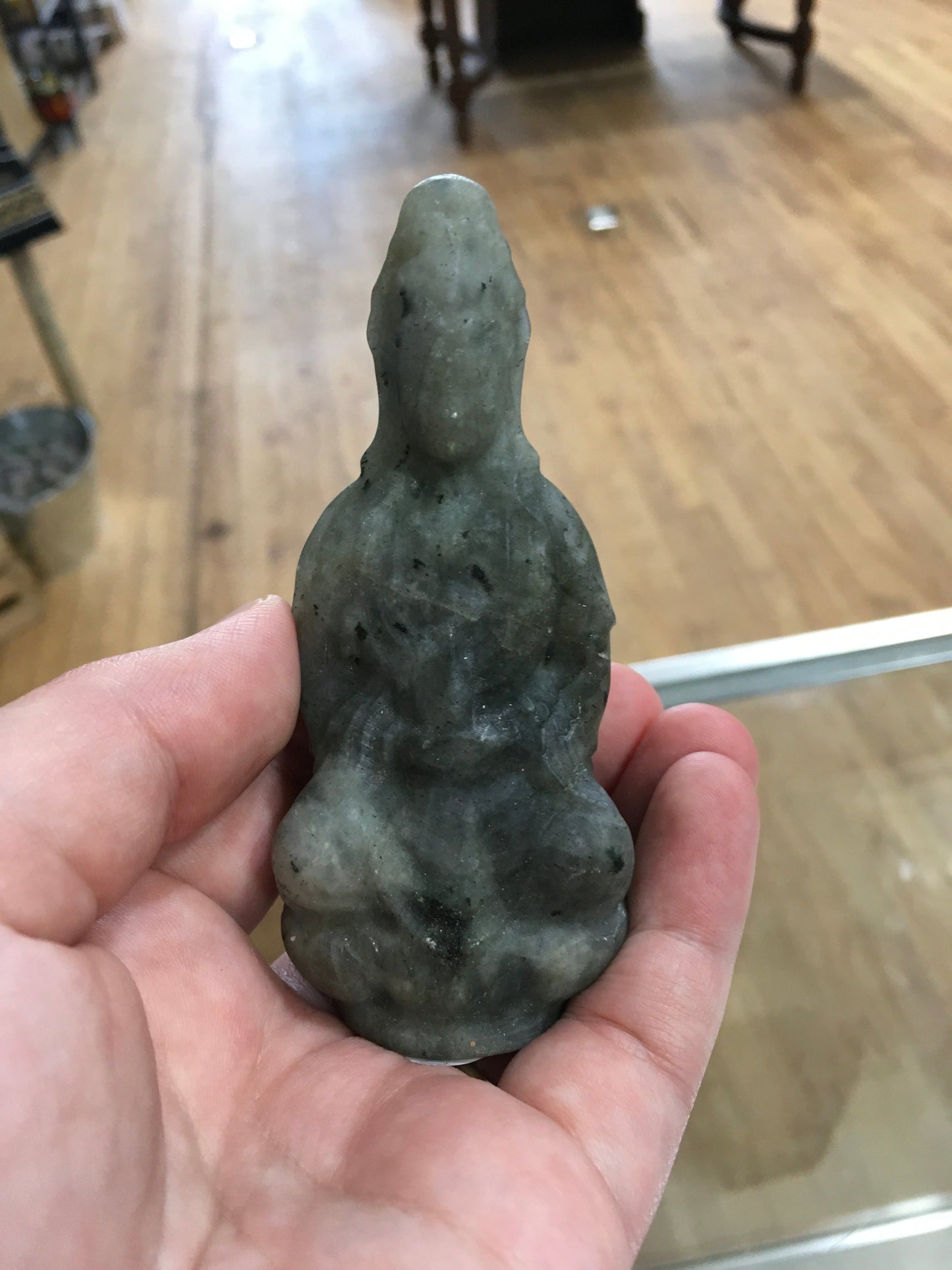 Hand-carved Goddess Guanyin statue made from genuine labradorite, featuring iridescent flashes of blue, green, and gold, displayed upright on a white background.