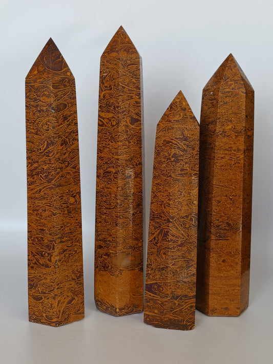 Hand-carved Golden Silk Jade tower featuring shimmering golden threads and a glossy finish, displayed on a white background.