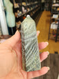 Hand-carved Green Zebra Jasper tower featuring bold green and white banded patterns, displayed on a white background.