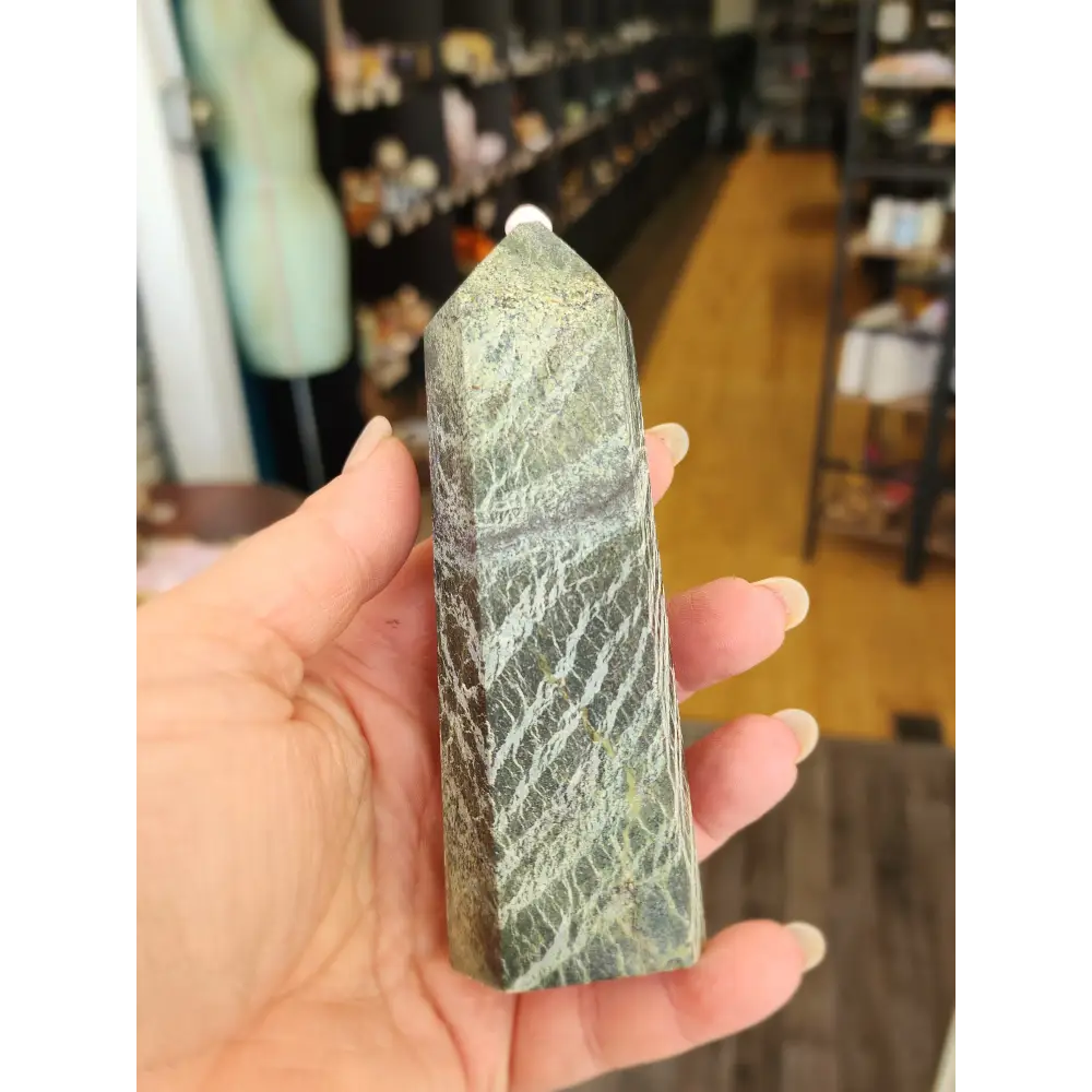 Hand-carved Green Zebra Jasper tower featuring bold green and white banded patterns, displayed on a white background.