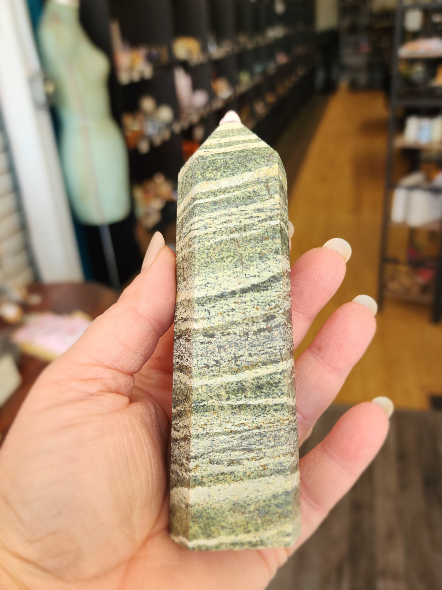 Hand-carved Green Zebra Jasper tower featuring bold green and white banded patterns, displayed on a white background.