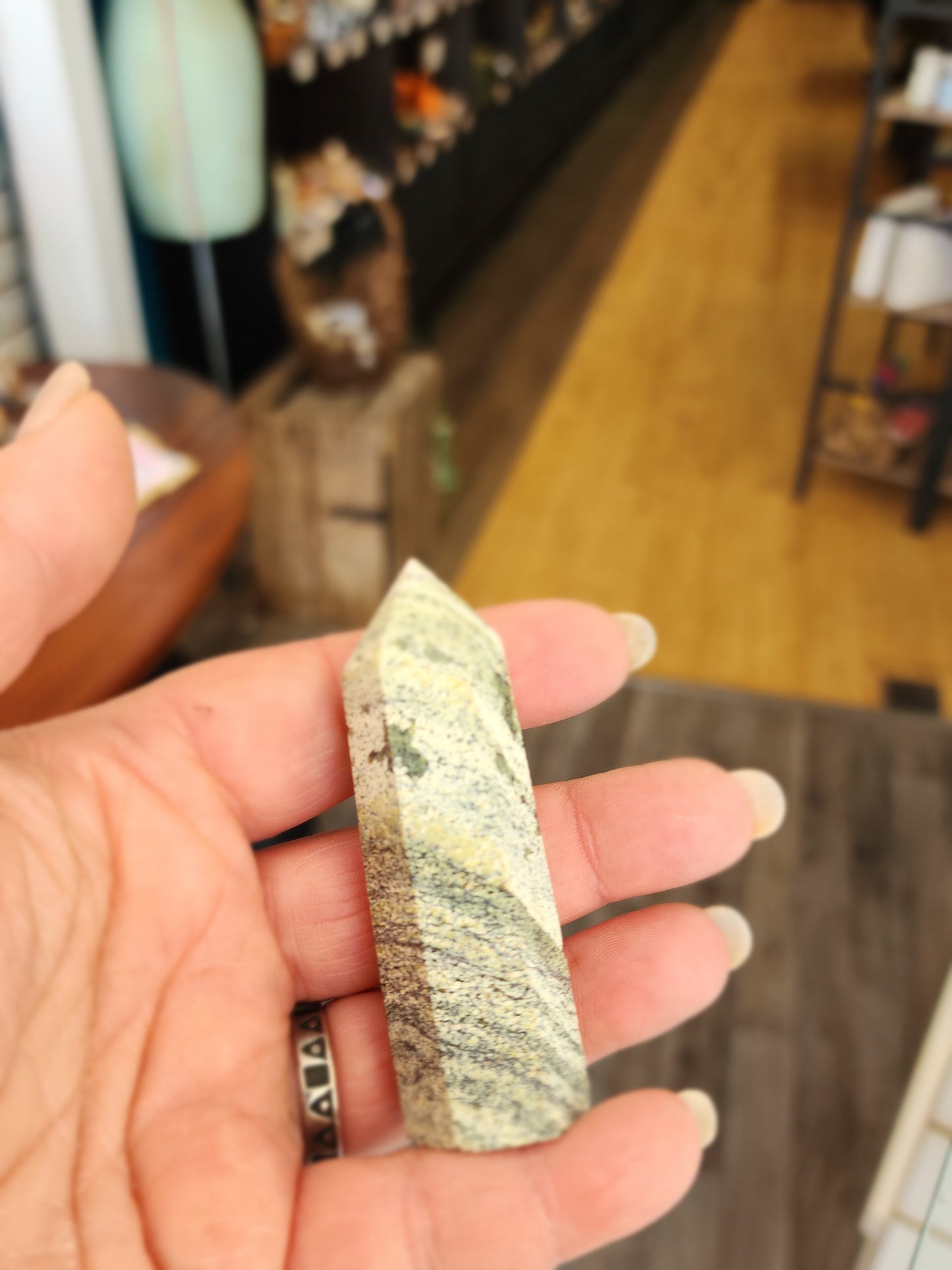 Hand-carved Green Zebra Jasper tower featuring bold green and white banded patterns, displayed on a white background.