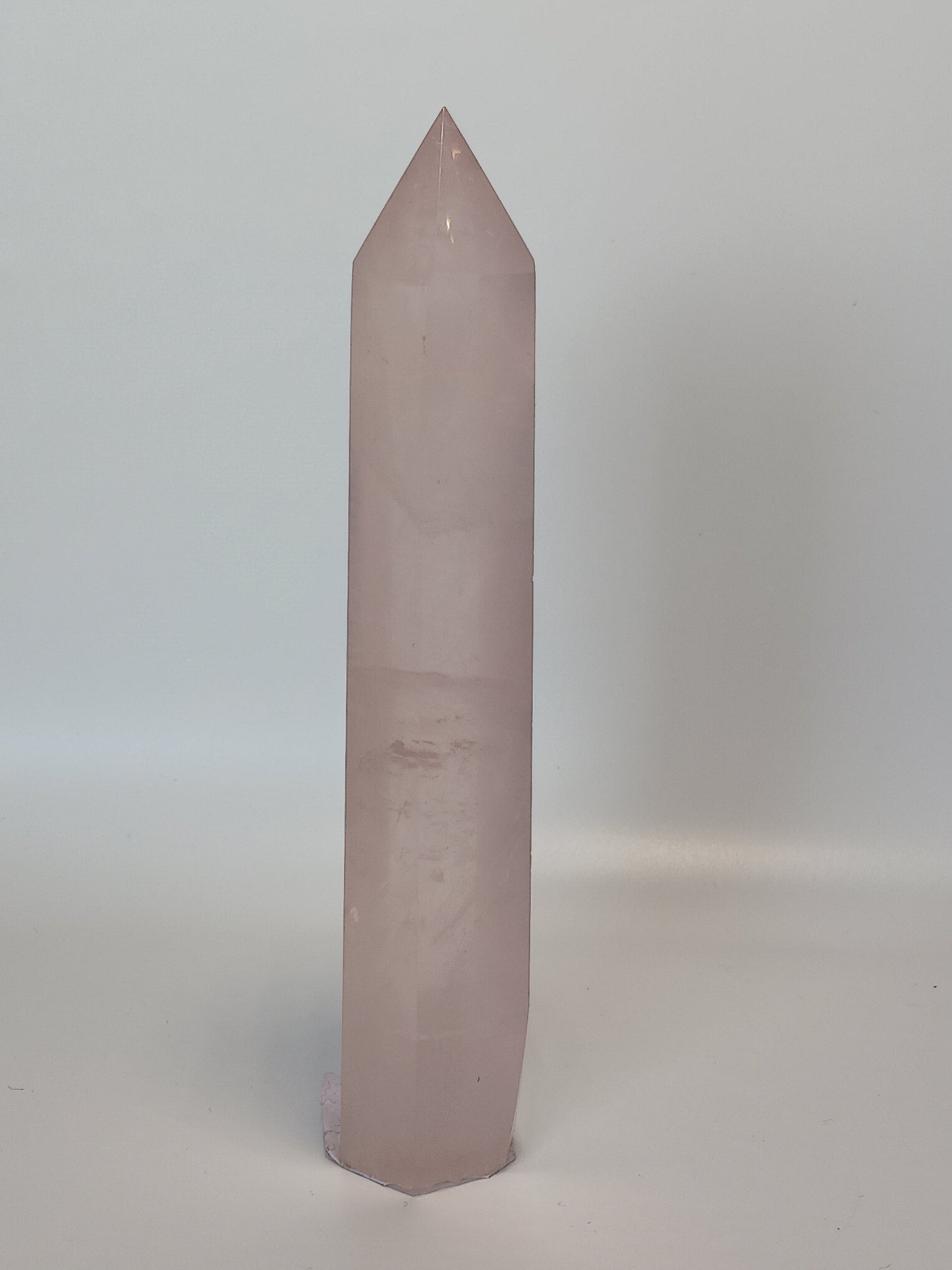 Hand-polished 5.5-inch Rose Quartz tower featuring vibrant, translucent pink hues, displayed on a white background.