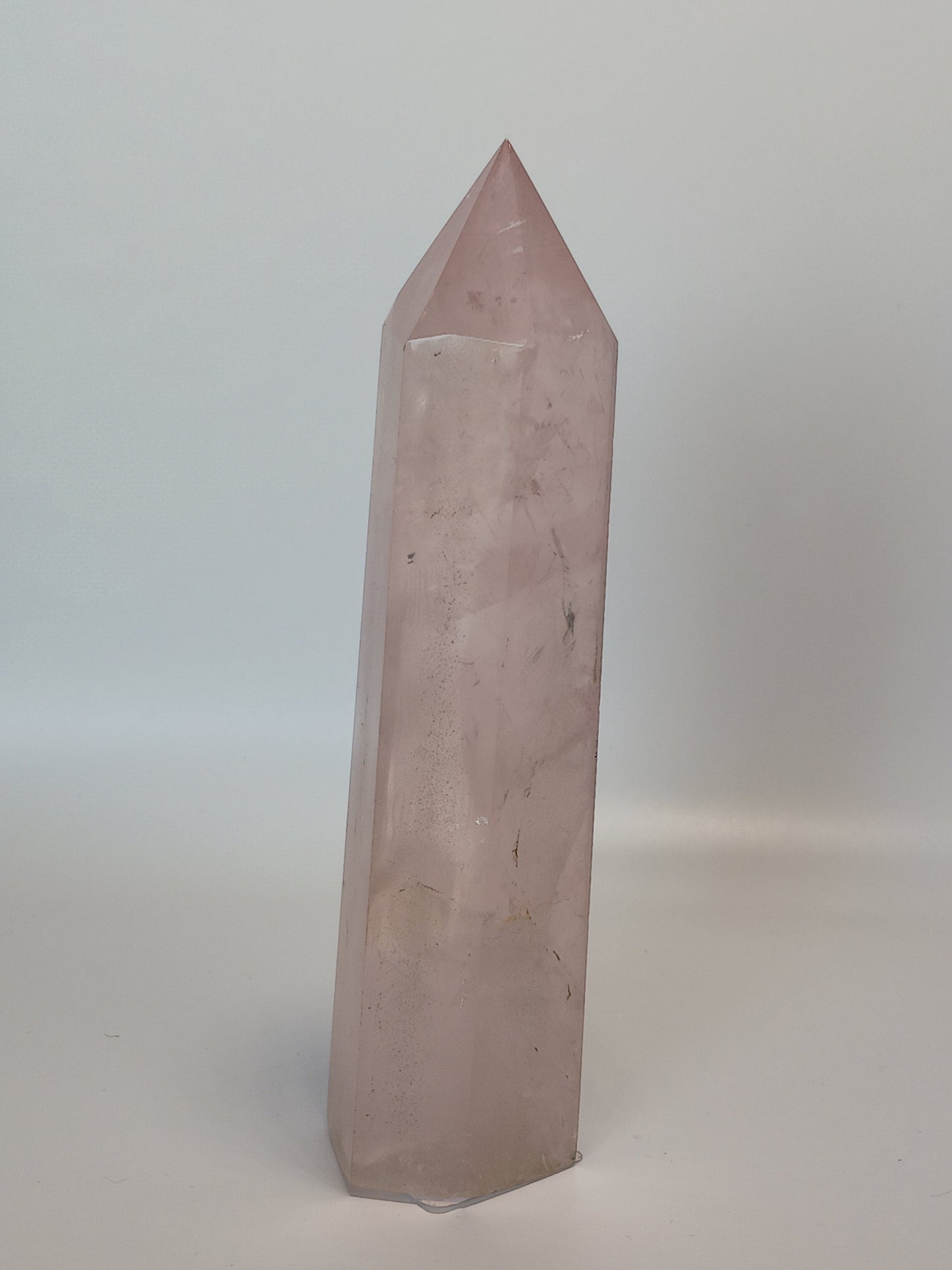 Hand-polished 5.5-inch Rose Quartz tower featuring vibrant, translucent pink hues, displayed on a white background.