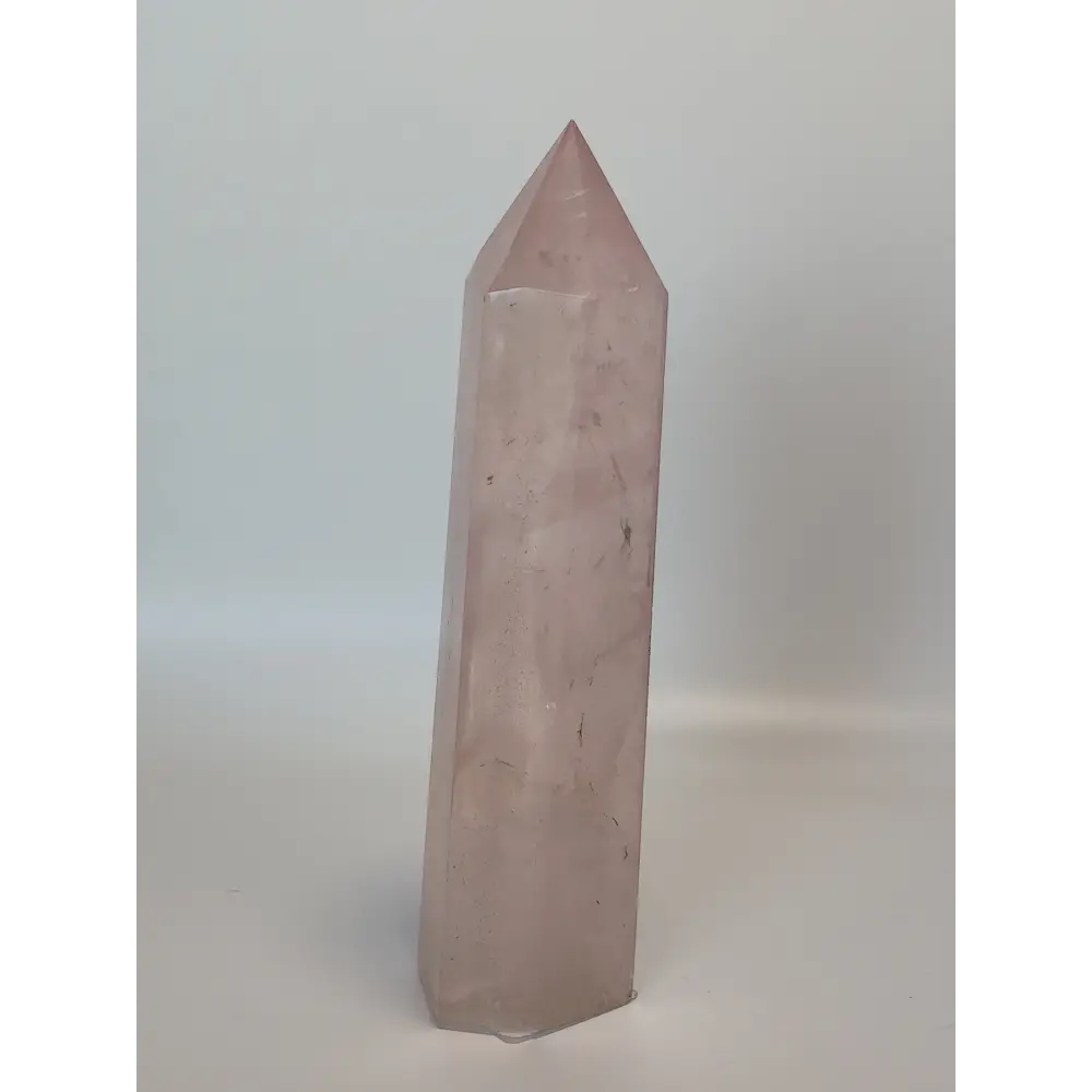 Hand-polished 5.5-inch Rose Quartz tower featuring vibrant, translucent pink hues, displayed on a white background.