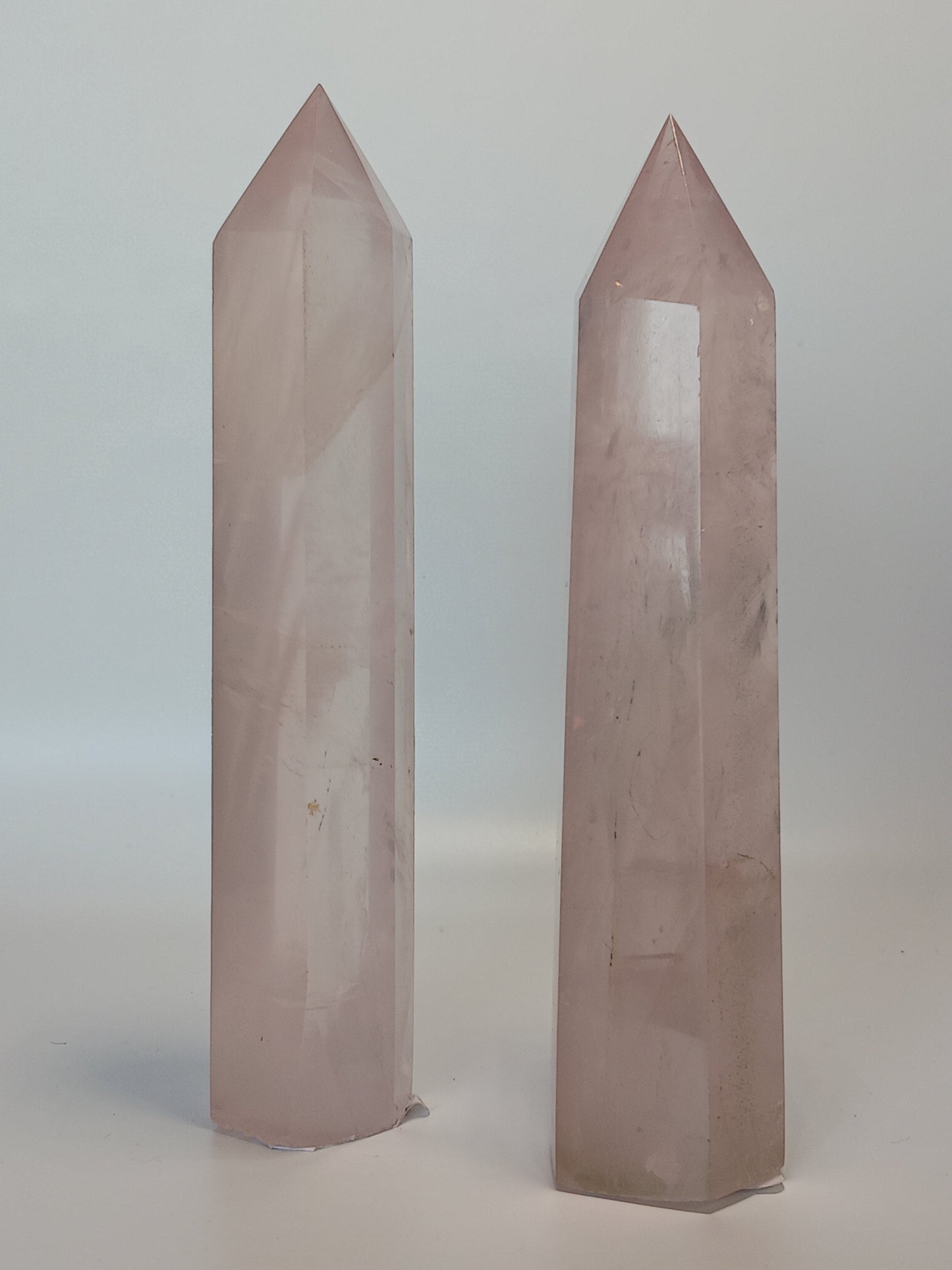 Hand-polished 5.5-inch Rose Quartz tower featuring vibrant, translucent pink hues, displayed on a white background.