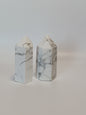 Hand-carved Howlite point featuring soft white coloring with graceful gray veining, displayed on a white background.