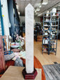 Huge clear quartz tower, polished and mounted on a sturdy stand, with brilliant clarity and natural inclusions, displayed on a white background.