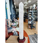 Huge clear quartz tower, polished and mounted on a sturdy stand, with brilliant clarity and natural inclusions, displayed on a white background.