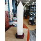 Huge clear quartz tower, polished and mounted on a sturdy stand, with brilliant clarity and natural inclusions, displayed on a white background.